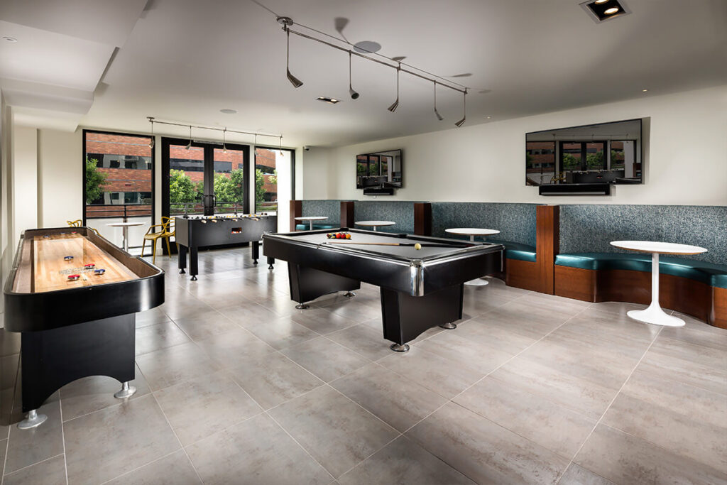 Clubhouse game room with billiards and foosball
