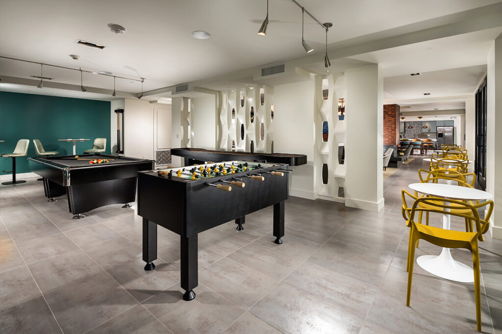 Clubhouse game room with billiards and foosball