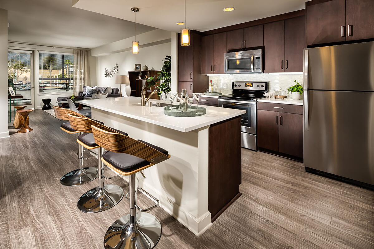 Kitchen with stainless steel appliances, tile back splash, and island seating