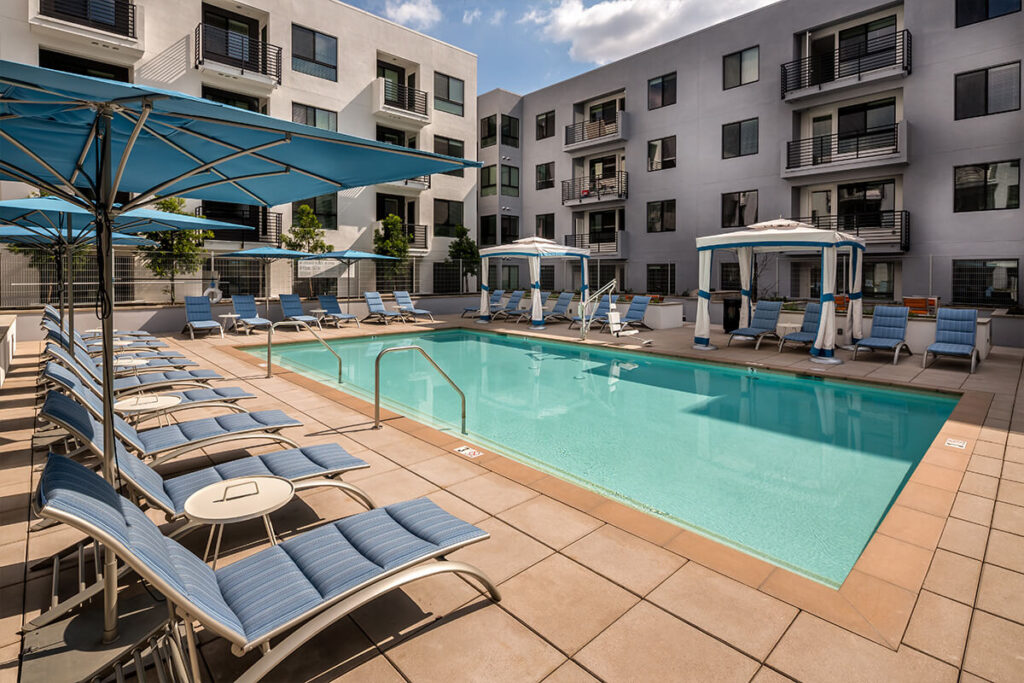 Pool with deck seating and cabanas