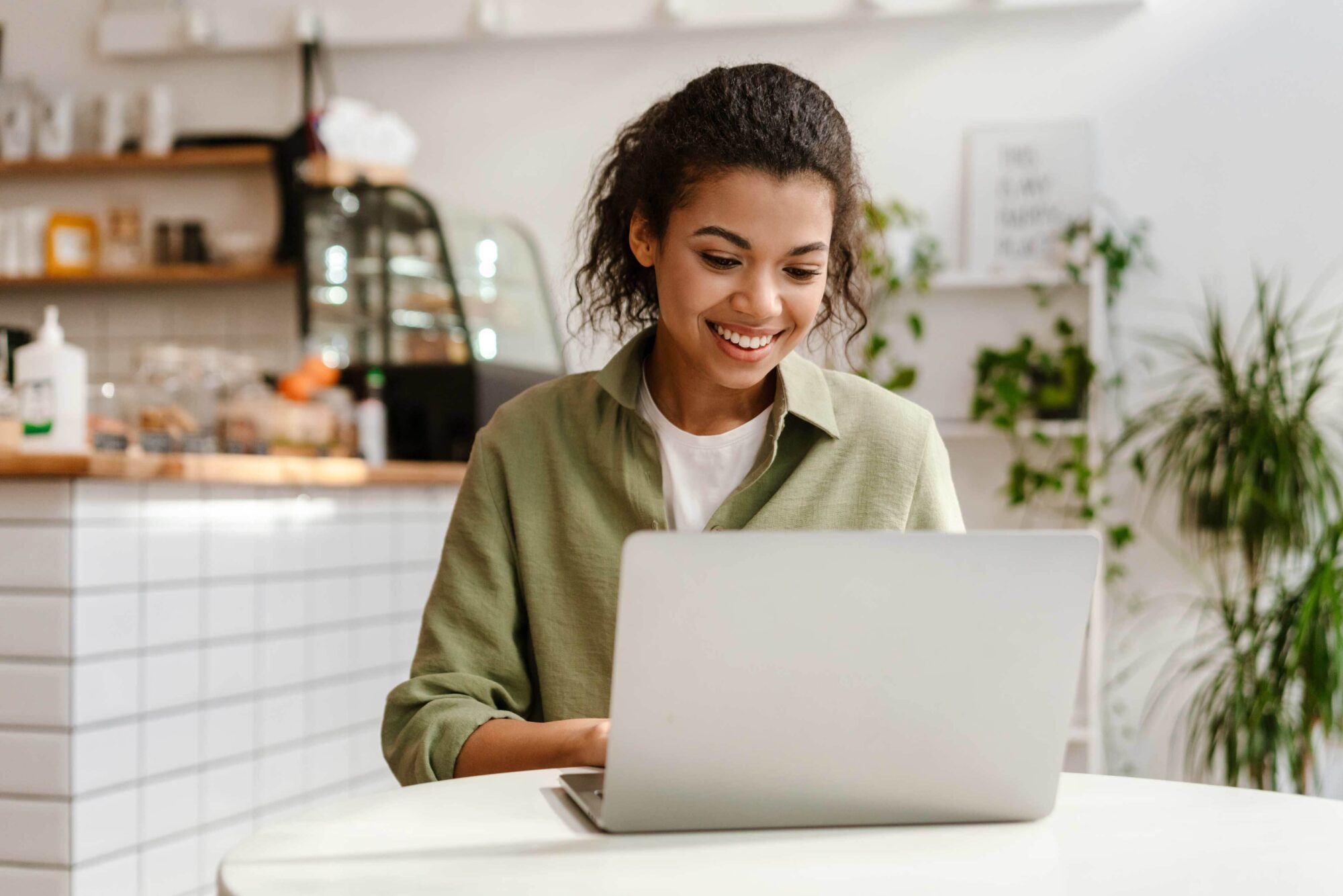 Young woman working at a laptop in a cafe